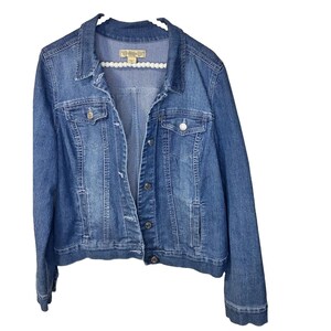 May include: A medium-wash blue denim jacket featuring a classic collar, long sleeves, and a front button closure. The garment includes two chest pockets with buttoned flaps and two side pockets. A label inside the neck reads Wild Fable.
