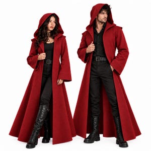 May include: Two long, deep red hooded cloaks featuring wide sleeves and an open front design. Each cloak is worn over a black shirt, black trousers, and black boots. The garments are floor-length with a structured hood and a flared silhouette.
