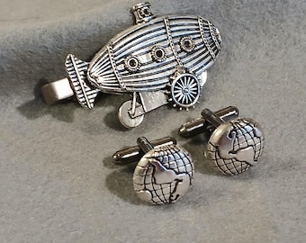 Pinza para corbata con forma de dirigible steampunk y gemelos con forma de globo terráqueo