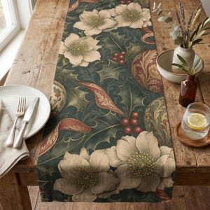 May include: A long rectangular table runner featuring a dark green background with a repeating pattern of cream-colored hellebore flowers, green holly leaves, red berries, and ornate swirling decorative elements in shades of rust and gold.