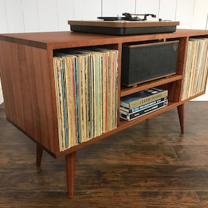 Solid mahogany turntable and stereo console with album storage. Mid century modern record player cabinet with vinyl storage.