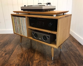 White oak turntable and stereo cabinet with album storage. Mid century modern stereo console with vinyl storage.