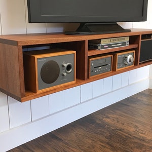 Solid mahogany floating media console. Wall mounted tv and video cabinet.