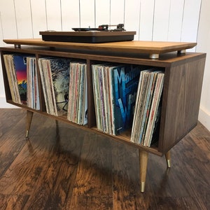 Solid walnut album storage cabinet with white oak accents. Mid century modern vinyl storage console with turntable platform.