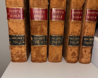 May include: A set of five antique books titled Scott's Bible, volumes I through V. Each book features a worn tan leather cover with red and black spine labels containing gold lettering. The spines display volume numbers and book ranges.
