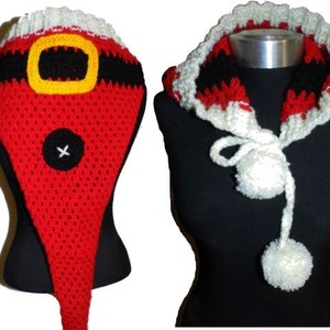 Puede incluir: Un gorro de Papá Noel de crochet rojo y blanco con un cinturón negro y un pompón blanco. El gorro está en un maniquí negro.