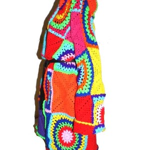 May include: A vibrant, patchwork crochet coat in a spectrum of colors including red, orange, yellow, pink, blue, and green. The coat features a hooded design and a mix of geometric and circular patterns, creating a bold and artistic look.