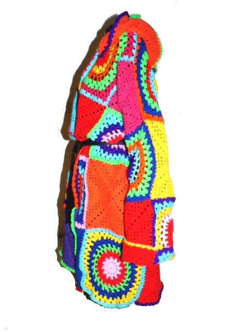 May include: A vibrant, patchwork crochet coat in a spectrum of colors including red, orange, yellow, pink, blue, and green. The coat features a hooded design and a mix of geometric and circular patterns, creating a bold and artistic look.
