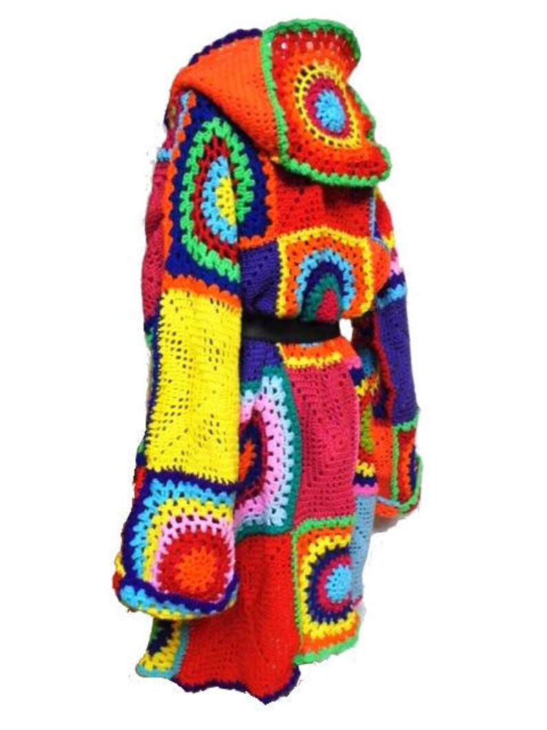 May include: A vibrant, handmade crochet coat featuring a patchwork design in a spectrum of colors including red, orange, yellow, green, blue, and purple. The coat has a hood and long sleeves, with a black belt at the waist.
