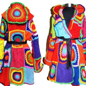 May include: Two colorful, handmade crochet coats. The coats feature a patchwork design with vibrant squares and circles in red, orange, yellow, blue, green, and purple. One coat is open with a black belt, the other is closed.