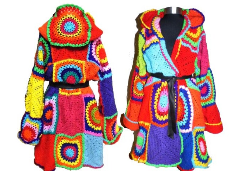 May include: Two colorful, handmade crochet coats. The coats feature a patchwork design with vibrant squares and circles in red, orange, yellow, blue, green, and purple. One coat is open with a black belt, the other is closed.