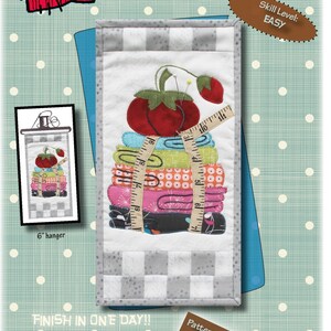 May include: Sew Necessary quilt pattern featuring a stack of fabric scraps, a tomato, and a measuring tape. The pattern is 6 inches by 12 inches and is easy to make. It is formatted for personal cutting machines. The pattern is from Patch Abilities, Inc.