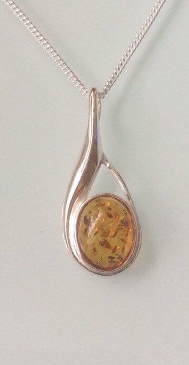 new sterling silver small tear drop pendant set with a single Amber cabochon stone on a 1.25mm chain