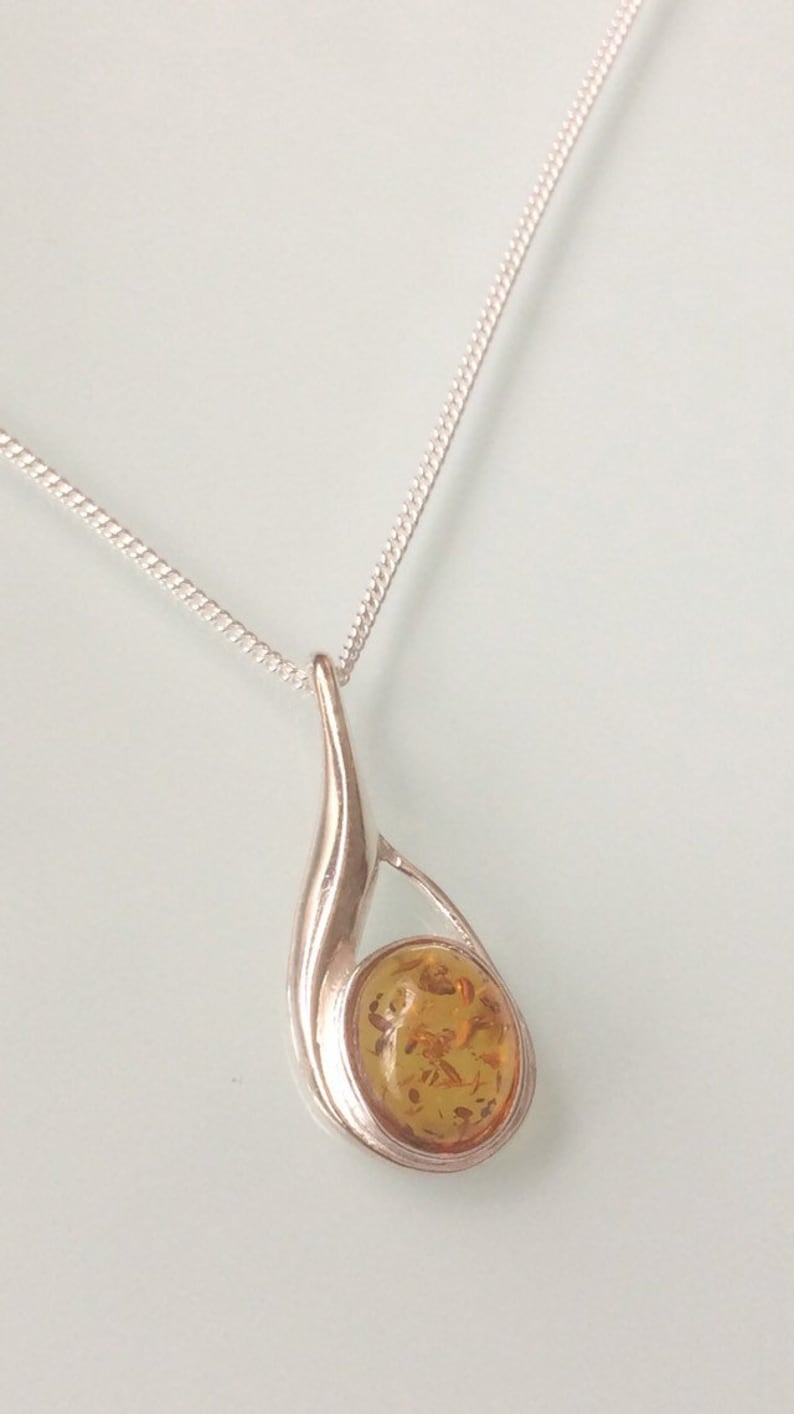 new sterling silver small tear drop pendant set with a single Amber cabochon stone on a 1.25mm chain
