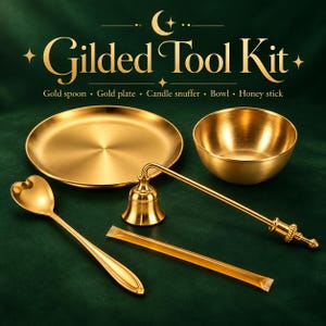 May include: A Gilded Tool Kit set featuring a gold-colored spoon with a heart-shaped bowl, a round plate, a bell-shaped candle snuffer, a small bowl, and a honey stick. The text Gilded Tool Kit is displayed above the items in gold lettering.