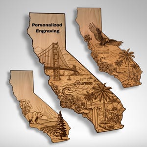 May include: Three wooden California state-shaped plaques with engraved designs. The largest features the Golden Gate Bridge and the Hollywood sign. The other two depict an eagle, bear, and other California landmarks. The text "Personalized Engraving" is at the top.