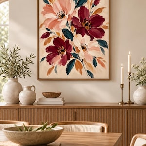 May include: A rectangular framed wall art piece featuring a painted floral arrangement with large blossoms in shades of deep burgundy, soft pink, and cream, accented by dark teal and muted orange leaves against a light beige background.