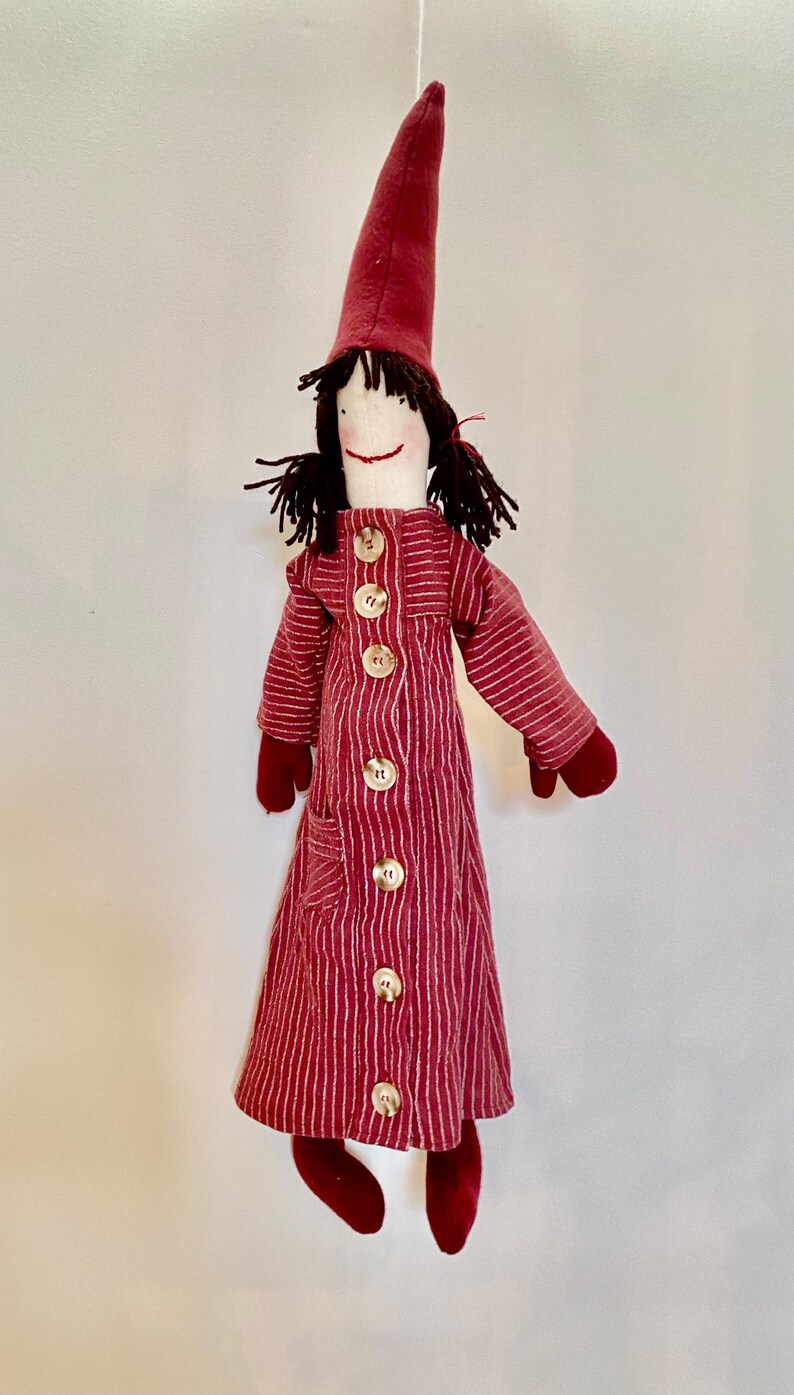 Op de afbeelding: Een witte keramische mok met een zwarte handgreep en de tekst "But First, Coffee" in een vetgedrukte, zwarte letter. De mok staat tegen een vage achtergrond, wat een gezellige setting suggereert.