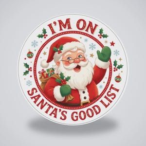 May include: A circular sticker featuring a cheerful Santa Claus wearing a red suit and hat, waving with a green mitten. The text I'M ON SANTA'S GOOD LIST is printed in red around the border, accented by holly leaves, berries, and snowflakes.