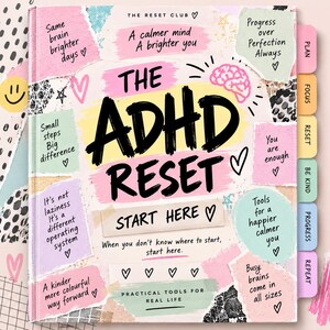 May include: A hardcover book titled The ADHD Reset with a pastel-colored cover featuring various text snippets, hand-drawn hearts, and a brain illustration. The book includes side tabs labeled Plan, Focus, Reset, Be Kind, Progress, and Repeat.