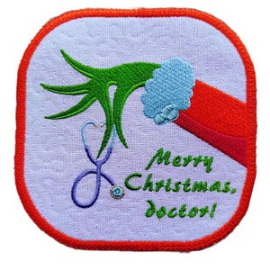 May include: Embroidered patch featuring a green hand and red sleeve with a blue cuff, holding a purple stethoscope. The text "Merry Christmas, doctor!" is in green. The patch has a red border and a light purple background.