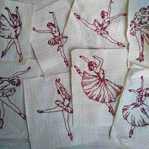 May include: Eight red embroidered images of ballerinas on white fabric squares. The ballerinas are in various poses, some are leaping, some are standing, and some are in mid-air.