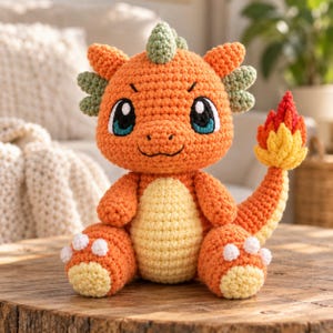 May include: A crocheted stuffed toy shaped like a dragon with orange yarn, a pale yellow belly, and light green spikes on its head and sides. It features large black and blue eyes and a tail ending in a flame-like design with red and yellow yarn.