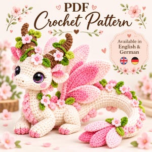 May include: A crochet dragon toy featuring a cream-colored body with pink accents, brown textured horns, and green leaves with small pink flowers. The text reads PDF Crochet Pattern, Available in English & German with UK and German flag icons.
