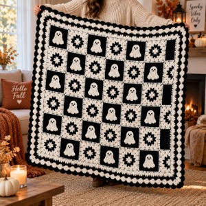 May include: A square crochet blanket featuring a checkerboard pattern of alternating black and white squares. The white squares display a ghost motif, while the black squares feature a star-like floral design. The blanket has a scalloped black border.