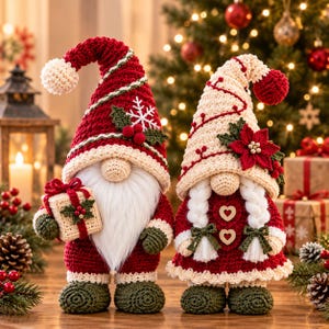 May include: Two crocheted gnome figures. The left gnome wears a red hat with a white snowflake and holds a small gift. The right gnome wears a cream hat with a red poinsettia and has white braided hair. Both have green boots.