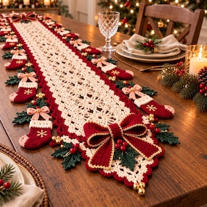 May include: A long, rectangular crochet table runner featuring a cream-colored lace center with a scalloped red border. The runner is decorated with small red stockings, pink bows, green holly leaves, red berries, and gold jingle bells.