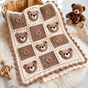 May include: A handmade crochet baby blanket featuring a repeating pattern of cream-colored squares and brown squares. The cream squares are adorned with appliqued brown bear faces, while the brown squares feature a raised floral texture.