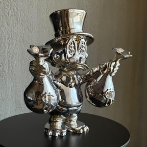 Krom Scrooge McAnka-skulptur, lyxig kromdekor
