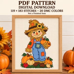 May include: A cross-stitch pattern PDF digital download featuring a scarecrow wearing a straw hat with a sunflower, blue overalls, and orange sleeves, surrounded by pumpkins and autumn leaves, with text stating 119 x 183 stitches and 20 DMC colors.