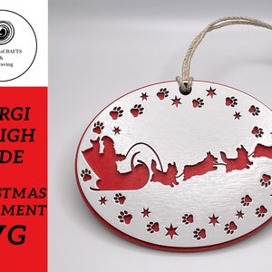 May include: A silver and red Christmas ornament featuring a Corgi pulling a sleigh with other Corgis. The ornament is decorated with paw prints and stars.