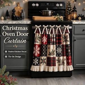 May include: A fabric oven door curtain featuring a patchwork design of red, black, and cream squares with patterns of snowflakes, pine branches, and plaid. The curtain has a ruffled bottom edge and is secured with five cream-colored fabric ties.