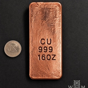 May include: A rectangular copper bar with a textured surface, stamped with the text CU 999 160Z. Beside the bar is a silver-colored 50 cents coin for scale. The bar has rounded corners and a metallic reddish-brown finish with visible surface grain.