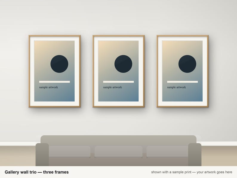 May include: A set of three rectangular picture frames with light wood borders. Each frame contains a print featuring a dark blue circle, a horizontal white line, and the text "sample artwork" on a blue and beige gradient background.