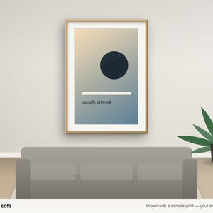 May include: A framed vertical print featuring a dark blue circle above a horizontal white line and the text sample artwork, set against a gradient background transitioning from light beige to blue, displayed in a wooden frame.