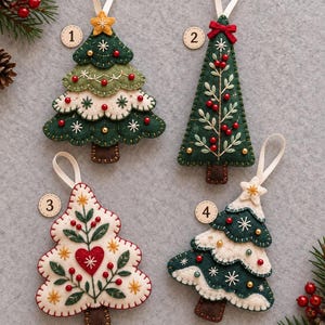 May include: Four felt Christmas tree ornaments labeled 1 through 4. Ornament 1 is a layered green and white tree with a yellow star. Ornament 2 is a tall green tree with red berries. Ornament 3 is a white tree with a red heart. Ornament 4 is a layered green and white tree.