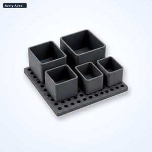 May include: A dark gray desk organizer set featuring a square base with a grid of circular holes and five open-top containers of varying sizes. The text Avery Apex is visible in the top left corner of the image. The containers are arranged on the base.