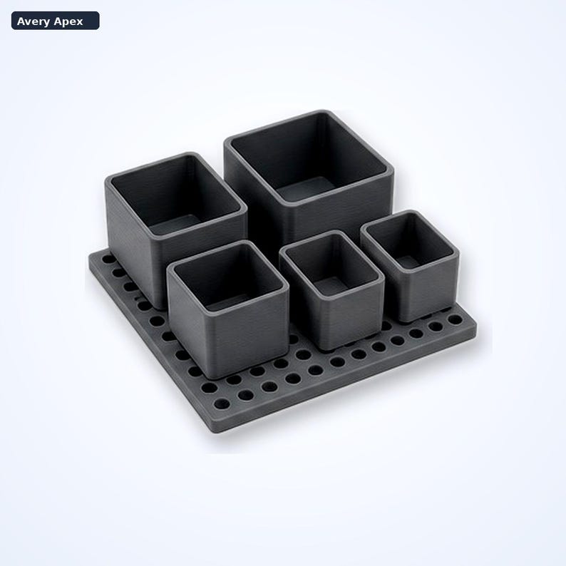 May include: A dark gray desk organizer set featuring a square base with a grid of circular holes and five open-top containers of varying sizes. The text Avery Apex is visible in the top left corner of the image. The containers are arranged on the base.