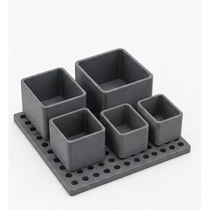 May include: A dark gray modular desk organizer set consisting of five square and rectangular open-top containers of varying sizes. The containers are arranged on a flat, rectangular base plate featuring a grid of circular holes throughout.