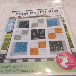 May include: A quilting pattern titled "Four Patch Fun" featuring a space-themed design with a blue, orange, white, and black color scheme. The pattern is designed by Sarah Price and is available on the website ItsSewEmma.com.