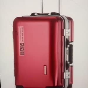 May include: A metallic red hard-shell carry-on suitcase with a retractable black handle, four black spinner wheels, and silver-toned latches. A vertical white sticker on the front features the text "Type are cool" with three small icons.