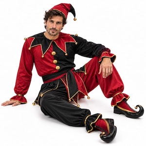 May include: A jester costume featuring a red and black color-blocked long-sleeve top with a jagged collar, a matching pointed hat, a waist sash, loose-fitting trousers, and curled-toe shoes, all accented with small gold bells throughout the garment.