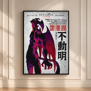 May include: A framed poster featuring the Devilman Crybaby anime character in black and magenta tones with large wings, looking upward. The text includes Devilman Crybaby, Cry For Love, and Japanese characters on a textured white background.