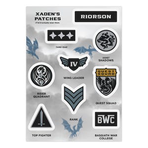 May include: A sticker sheet titled Xaden's Patches featuring various military-style emblems. Designs include the name Riorson, three stars, a dragon signet, a winged IV shield, a sword triangle, a rank chevron, and a Quest Squad shield.