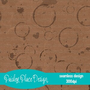 May include: A seamless design featuring a brown background with coffee ring stains and splatters. The design includes the text "Paisley Place Design" and "seamless design 300dpi" in a teal banner.