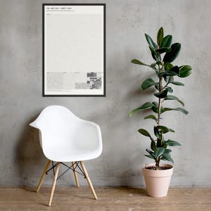 May include: A framed rectangular wall art print featuring a white background with dense black text and a grid of small gray and black squares at the bottom. The text at the top reads THE v402 RAIL, NINETY DAYS. The frame is thin and black.
